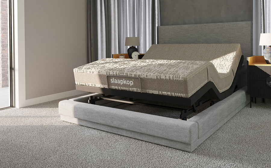 Slaapkop latex mattress on an adjustable bed frame in a styled bedroom